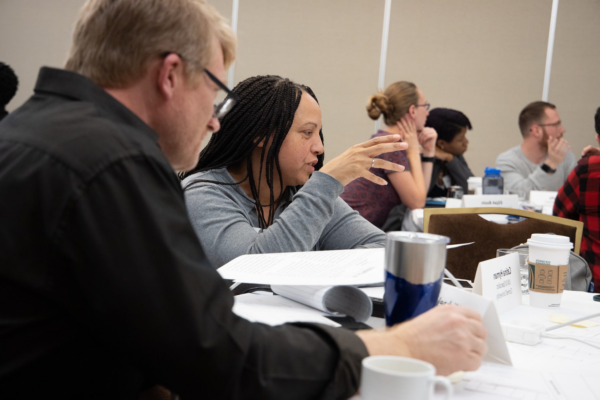 An attendee shares in a group discussion