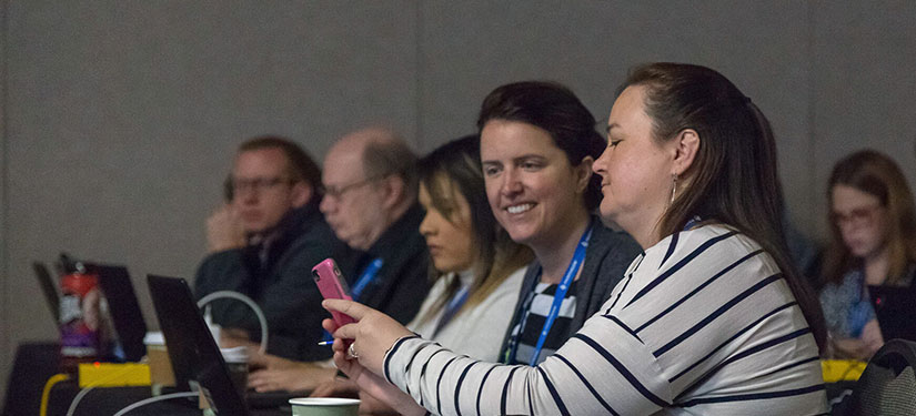 Attendee sharing phone screen with another attendee