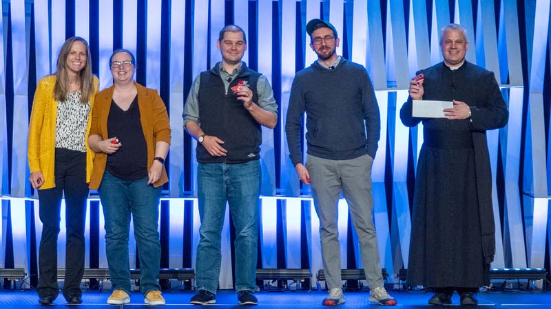 2023 Annual Conference lightning talk presenters on stage with their mini red stapler awards