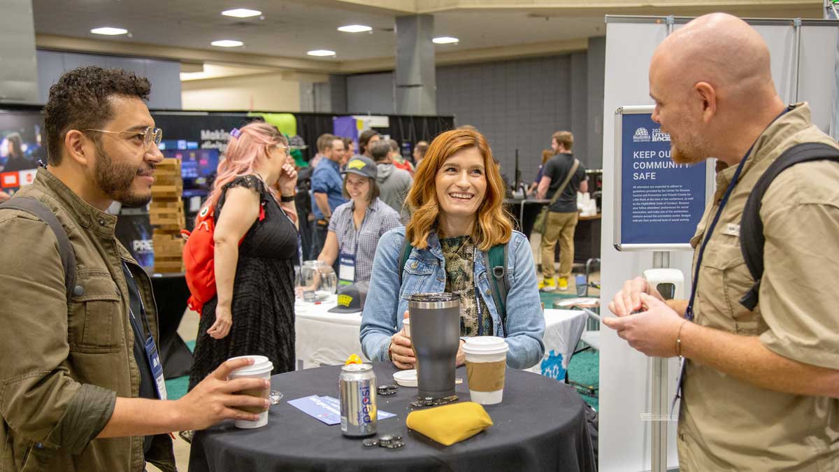 Attendees chatting in the expo hall at the annual conference