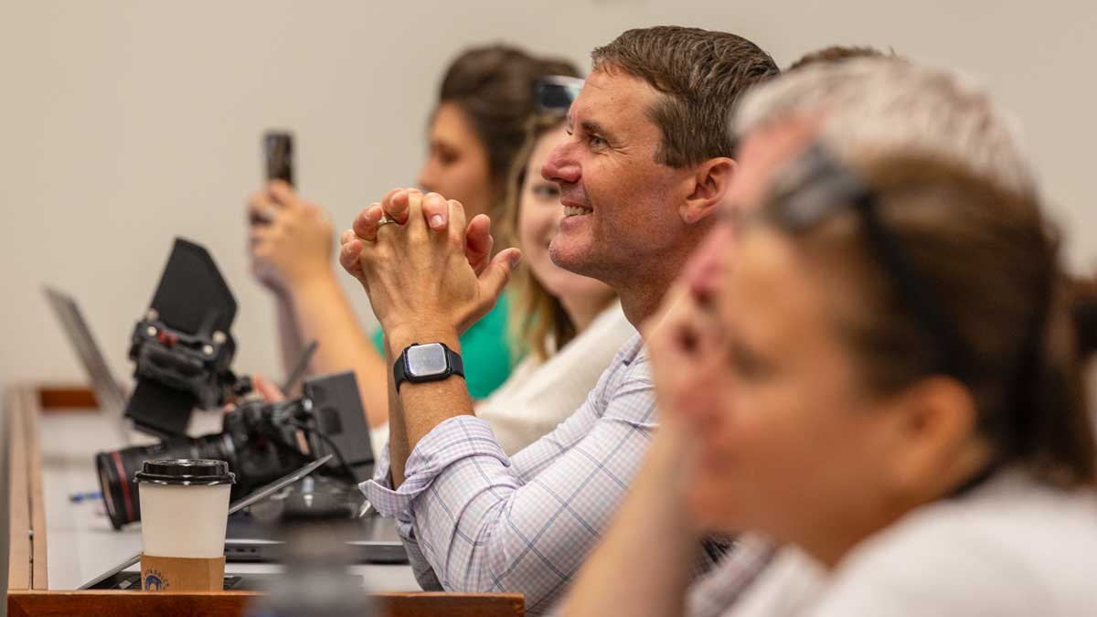 Attendees smiling at regional conference presentation