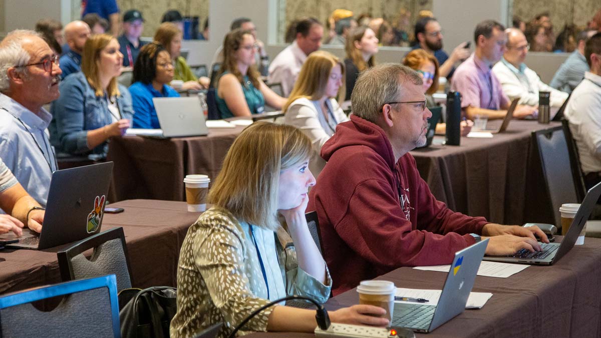 Attendees learning at annual conference session