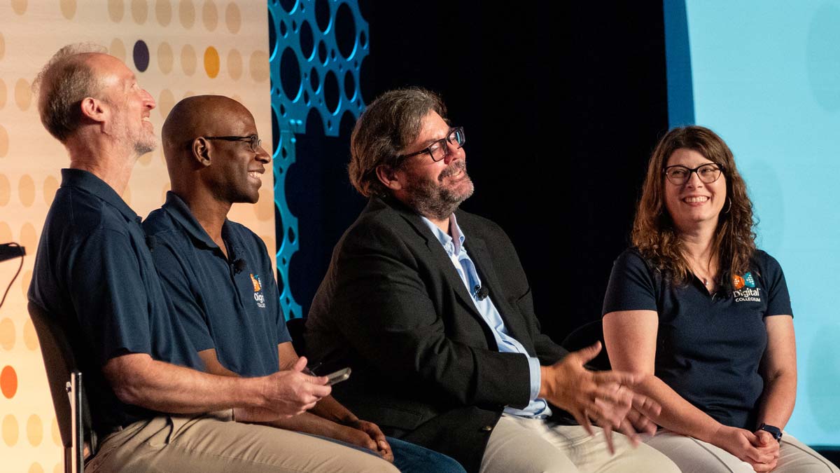 DigiCol leaders chuckle on stage during the 2025 Collegium Chat