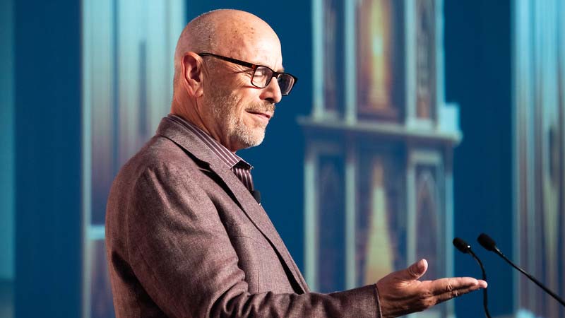 Keynote Jim Sterne looks at his hand pretending to read his phone